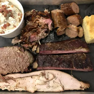 The Hogwood Sampler (pulled pork, sausage, beef brisket, smoked turkey, and pork ribs, along with cornbread, icebox pickles, and a side)