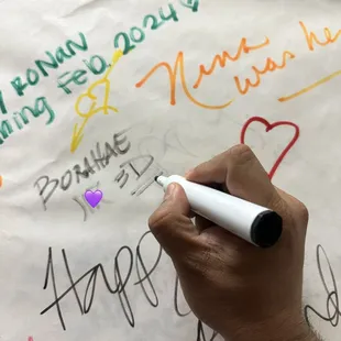 a person writing on a piece of paper