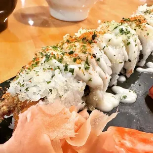 a sushi roll on a black plate