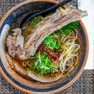 a bowl of ramen and chopsticks