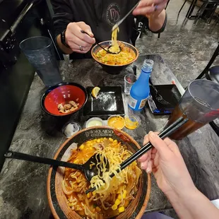 a man eating a bowl of ramen