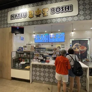 two people standing at the counter