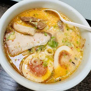 a bowl of ramen with a spoon