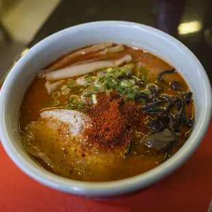 a bowl of ramen on a red tray