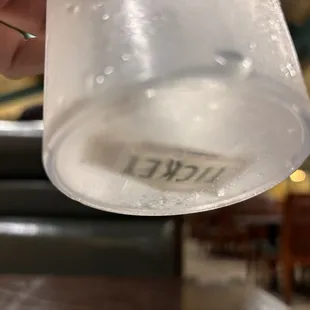 Ticket inside of the cup of water.