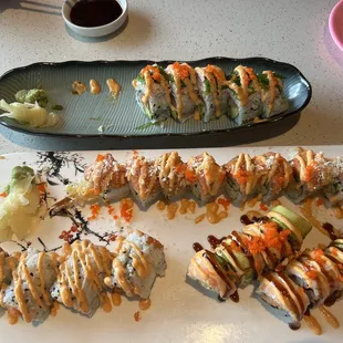 a plate of sushi and a platter of other sushi