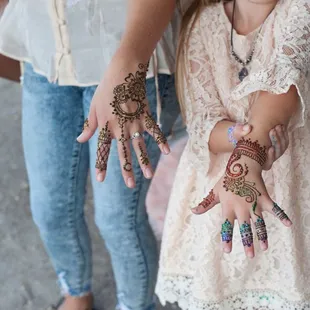 Henna for two! Optional glitter can be applied over top of the henna paste.