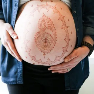 Paisley henna design on an expecting mother.
