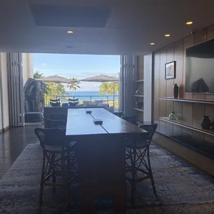 a dining room with a view of the ocean