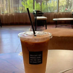 a cup of iced coffee on a table