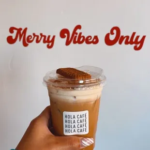 a hand holding a cup of coffee