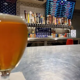 a glass of beer on a bar