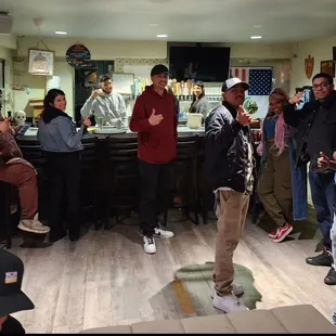 a group of people standing around a bar