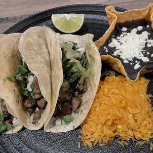 Dry Tacos de Asada that seemed to be missing the badly needed avocado sauce to help the overcooked steak