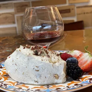 a piece of cake and a glass of wine