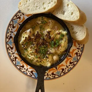 a bowl of soup with bread on a plate