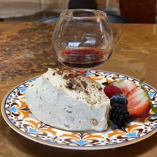 a piece of cake and a glass of wine