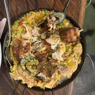 Paella - good presentation, temperature, seafood amount, while lacking spice, is very soupy, and scattered grinds when chewing.