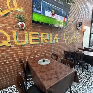 a television mounted on a brick wall