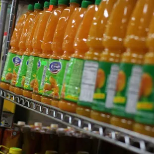 a shelf of orange juice
