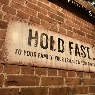 a sign on a brick wall