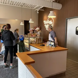 a group of people in a bakery