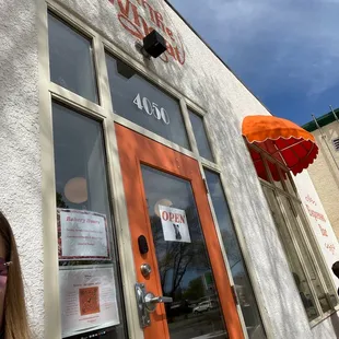 a woman standing outside of a restaurant