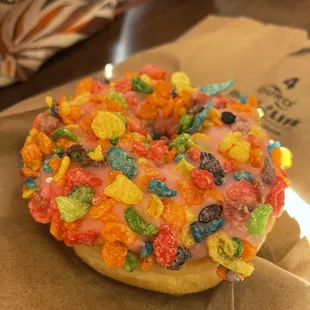 Strawberry frosted donut with fruity pebbles on too