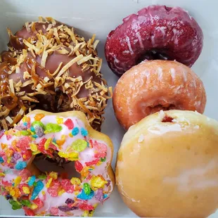 Samoa &amp; fruity pebbles mochi donuts (left) and red velvet cake, strawberry cake, and guava filled donuts (right)