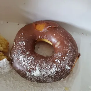 Big delicious chocolate covered donut, next to a half eaten powdered donut!!  So good!!