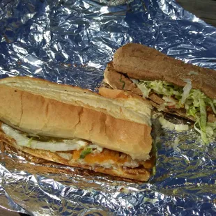 Two of &quot;The Hook&quot; fish sandwich halves, one on white, and one on wheat . . .
