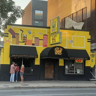 people standing outside of a restaurant
