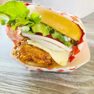 a chicken sandwich with cheese and lettuce