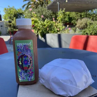 a bottle of juice and a napkin on a table