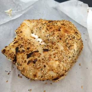 Everything bagel (partially eaten), olive cream cheese