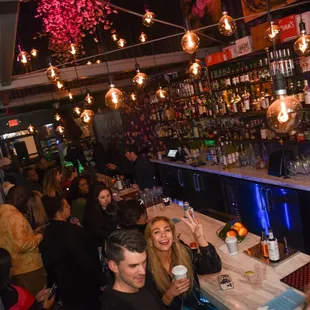 people sitting at the bar and drinking