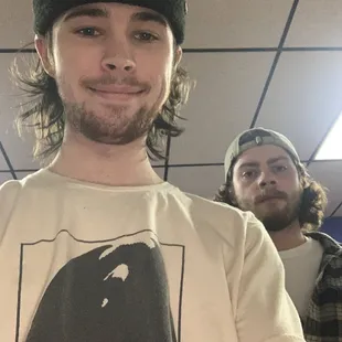 a man wearing a t - shirt with a shark on it