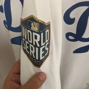 It's literally a 90* angle sitting on the arm like a bent playing card. Since they used such a high heat on the press, it's permanent.