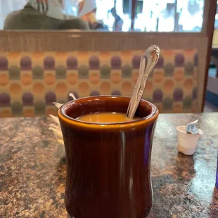 a cup of coffee with a spoon in it
