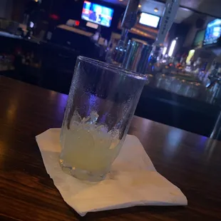 a drink in a glass on a napkin