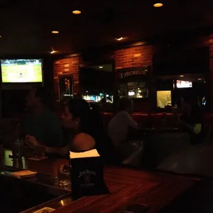 a group of people sitting at a bar