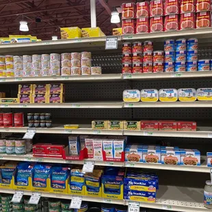 Details! Flat cans like sardines are placed on edge so you can see easily... vast majority of regular round cans are rotated label forward.
