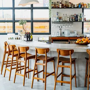 a bar with chairs and a counter