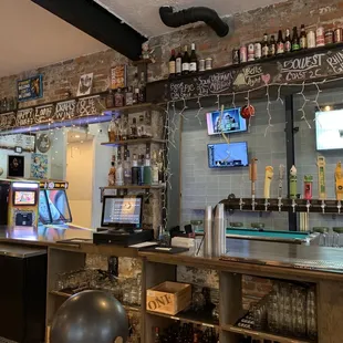 a bar with beer taps and a television