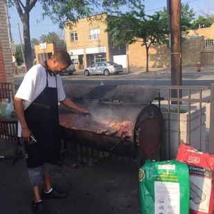 The owner cooking the ribs in the parking lot...
