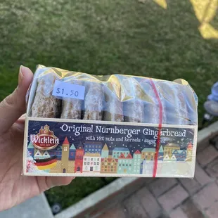 a hand holding a package of bread