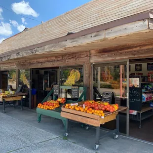 a man standing in front of a fruit stand