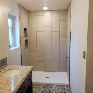 a bathroom with a shower and sink