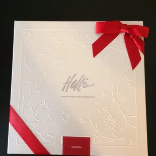 a white box with a red ribbon
