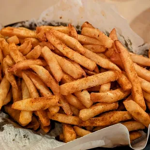 a basket of french fries with ketchup